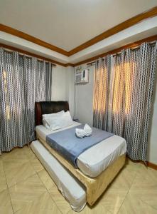 a bed in a room with curtains and a bedvisor at Exclusive Beachfront House at San Juan La Union in San Juan