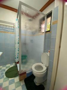 a bathroom with a toilet and a shower at Exclusive Beachfront House at San Juan La Union in San Juan