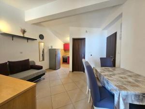 a kitchen and a living room with a table and chairs at Apartments Andrea in Podstrana