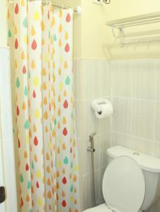a bathroom with a toilet and a shower curtain at Private Retreat @ Poolfront in Santa Rosa