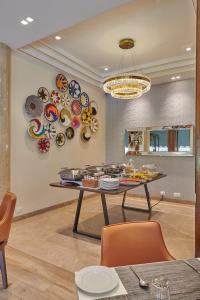 a dining room with a table and plates on the wall at Regent Hotel Andheri in Mumbai