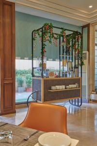 a room with a table and a mirror with flowers at Regent Hotel Andheri in Mumbai