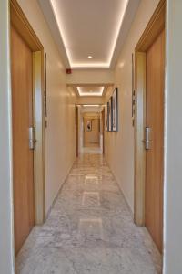 a corridor in a building with a long hallway at Regent Hotel Andheri in Mumbai