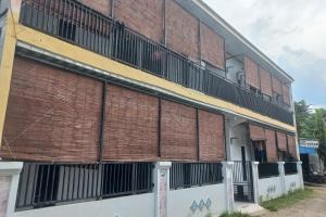 a brick building with balconies on the side of it at SPOT ON 93886 Kost Zalfa Amalia Syariah in Tegal