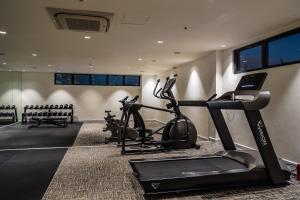 a gym with two tread machines and a treadmill at Summit Hotel Naga in Naga