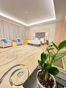a hotel room with a bed and a potted plant at أستديو فندقي ديلوكس in Jazan