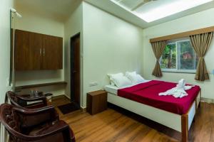 a bedroom with a bed with a white dog on it at White Water Resort dandeli in Dandeli