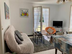 Televízia a/alebo spoločenská miestnosť v ubytovaní Maison plain-pied proche plage avec jardin clos - 5 pers - FR-1-540-262