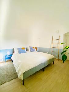 a bedroom with a bed with a ladder on the wall at Villa Filou in Santa Lucia +58 photos