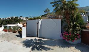 a white refrigerator in a yard with a palm tree at B&B Villa Cristina in Anacapri