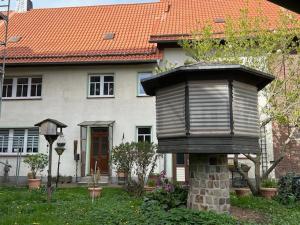 a house with a bird feeder in front of it at Ferienwohnung Knopp in Ilsenburg