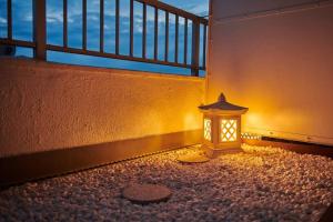 a lantern sitting in the corner of a building at 組紐の間 in Tokyo