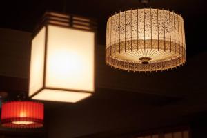 a chandelier hanging from a ceiling with a light at 組紐の間 in Tokyo