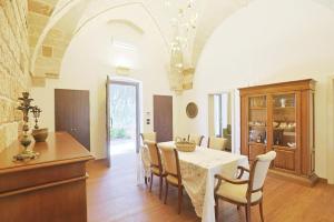 una cucina e una sala da pranzo con tavolo e sedie di villa dei cento Pini a Monteroni di Lecce