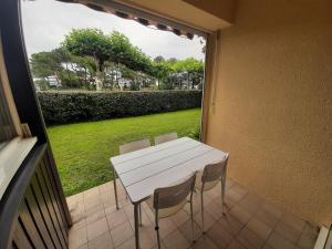 una mesa blanca y sillas en un balcón con ventana en Appartement Capbreton, 2 pièces, 4 personnes - FR-1-239-987, en Capbreton