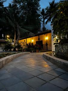 a walkway leading to a building at night at Mermaid Island Beach Resorts in Puducherry
