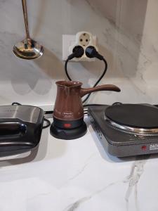 a tea kettle on a counter next to a toaster at Center Cozy Nest in Tirana