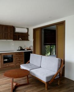 a living room with a couch and a table at YEN Hidden Valley in Cat Ba