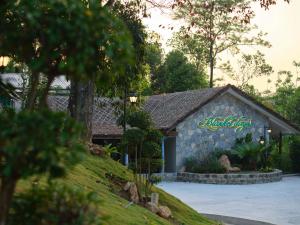 a building with a sign on the side of it at Blanket Days Resort and Spa in Thekkady