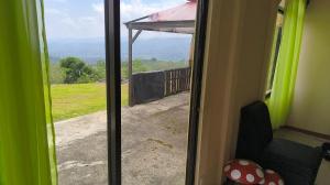 a sliding glass door with a view of a yard at CASA DE CAMPO in Turrialba