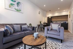 a living room with a couch and a table at Fantastic 1 Bedroom Apartment in Bolton in Bolton