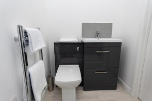 a bathroom with a white toilet and a sink at Fantastic 1 Bedroom Apartment in Bolton in Bolton