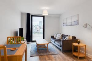 a living room with a couch and a table at Modern 1 Bedroom Flat In Central Birmingham in Birmingham