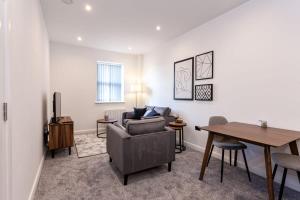 a living room with a couch and a table at Modern 1 Bedroom Apartment in Bolton in Bolton