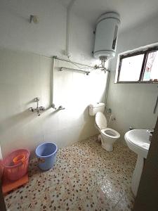 a bathroom with a toilet and a sink at Forest inn in Pahalgām