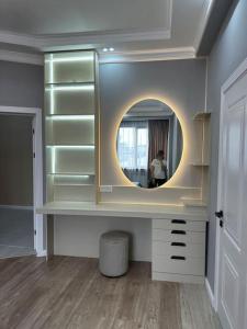 a dressing room with a mirror and a woman in a mirror at Your home away from home. in Bishkek