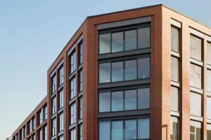 a red brick building with black windows at Stylish 1 bed flat in Central Birmingham in Birmingham