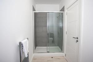 a shower with a glass door in a bathroom at Cosy 1 Bedroom Apartment in Bolton in Bolton