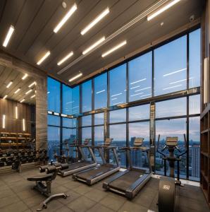 a gym with a view of the city at Modern condo nr BTS ONNUT WIFI in Bangkok