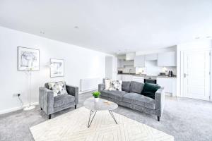 a living room with two couches and a table at Modern 2 Bedroom Apartment in Preston in Preston