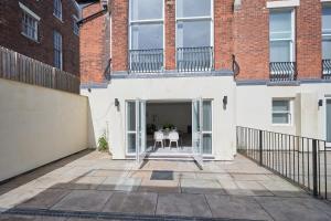 a patio with a table and chairs in a building at Modern 2 Bedroom Apartment in Preston in Preston