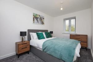 a bedroom with a large bed with green pillows at Lovely brand new 3 bedroom city centre house with garden in Derby