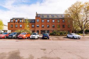 a group of cars parked in a parking lot in front of a building at Budget 1 Bedroom Apartment in Central Ipswich in Ipswich