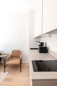 a kitchen with a chair and a table at 2ndhomes Modern & Stylish Studio close to the Sea in Helsinki