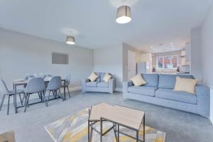 a living room with a couch and a table at Spacious 3 Bedroom House with Garden in Birmingham in Birmingham
