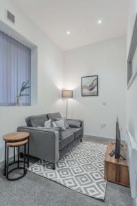 a living room with a couch and a table at Modern 1 Bedroom Apartment in Dudley in Brierley Hill