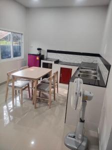 a kitchen with a table and a stove top oven at Family house villa in Ban Khlong Khamao (2)