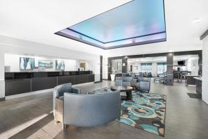 a large lobby with chairs and a large screen at La Quinta by Wyndham Houston Hobby Airport in Houston