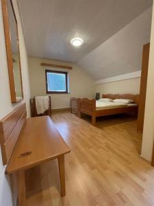 a room with a bedroom with a bed and a table at APARTMANI VISOLE in Slovenska Bistrica