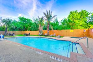 a swimming pool in a yard with a fence at La Quinta by Wyndham Houston Hobby Airport in Houston