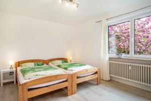 a bedroom with a bed and a window at Ferienwohnung Achraintal 3 in Lindau