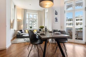 a dining room and living room with a table and chairs at Baltic Sun W6 in der Villa Sonneck in Ostseebad Sellin