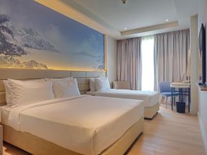 A bed or beds in a room at Cititel Express Kota Kinabalu