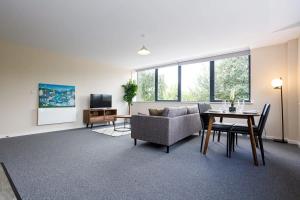 a living room with a couch and a table at Stylish and Bright 2 Bedroom Apartment Manchester in Manchester
