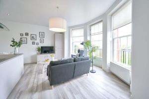 a living room with a couch and a tv at Beautiful 2 Bed Apartment in Preston in Preston