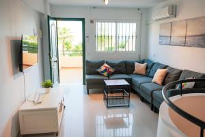 a living room with a couch and a table at Casa Lince: 2/2 in Marbella in Marbella